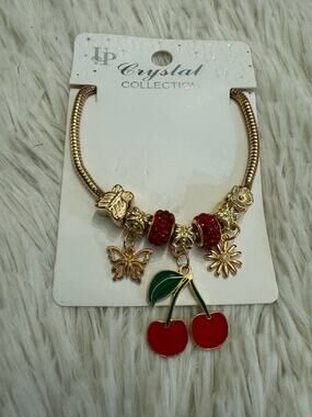 Gold & red cherry bracelet with butterfly and flower charms adjustable